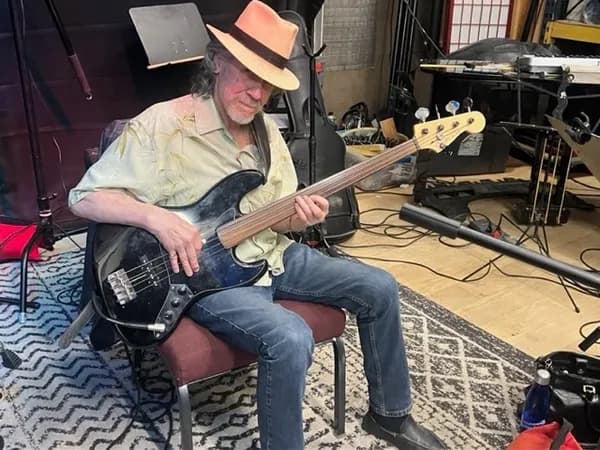 Lenny Charles plays guitar